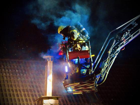 Unter Atemschutz bekämpfte ein Team aus dem Korb der Drehleiter den Kaminbrand von oben.  FOTO: ANDREAS DUNKER